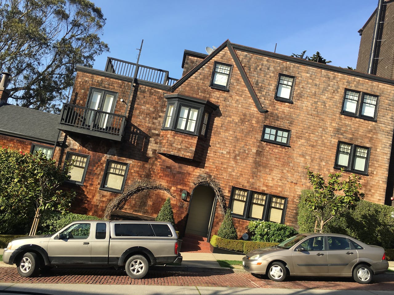 Distinctive brick architecture with parked vehicles on a sunny day in San Francisco.